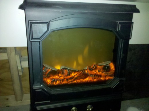 Keeps me warm under my station. Nothing like a fake fireplace!