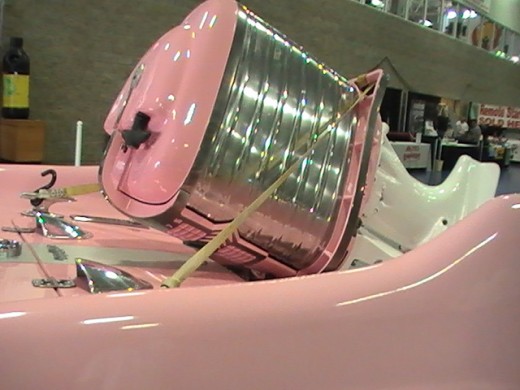 outboard motor in chrome and pink and white