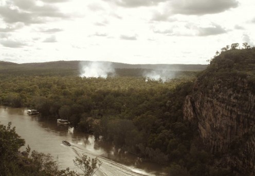 Smoke rising slowly in the afternoon heat