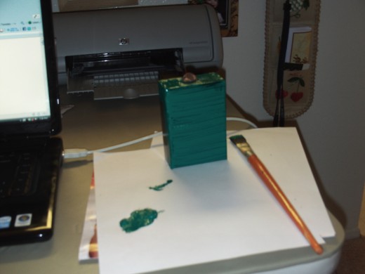 Here I have applied the green acrylic paint to one side of the box.