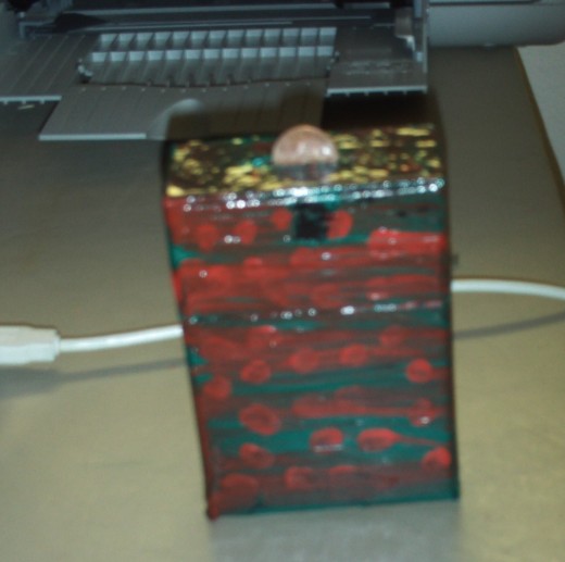I applied mod podge to the box I painted, which makes the completed bank have a lustrous shine.  This step is optional.
