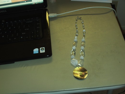Here is a picture of the completed necklace with a sparkly mother of pearl shell pendant.