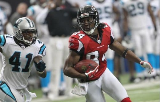 Atlanta Falcons wide receiver Roddy White (84) is chased by Carolina Panthers cornerback Captain Munnerlyn (41) during an NFL football game at the Georgia Dome in Atlanta Sunday, Jan. 2, 2011. (AP Photo/John Bazemore) 