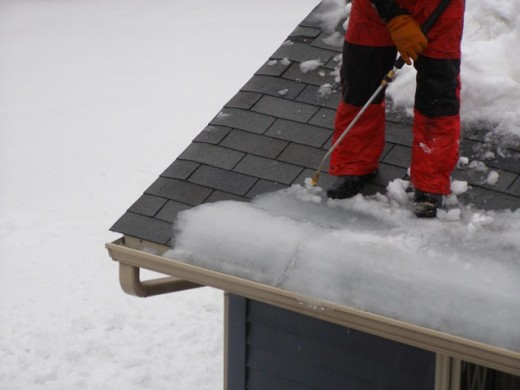 An ice dam that is being removed from the edge of a roof. These homeowners were experiencing a lot of water entering their home.