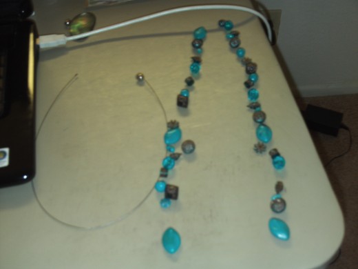 Assemble the pattern of the beads you would like to accent your mother of pearl pendant.