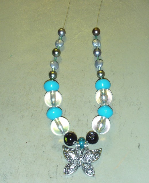 Here I added another fake dark silver pearl to each side of the necklace.
