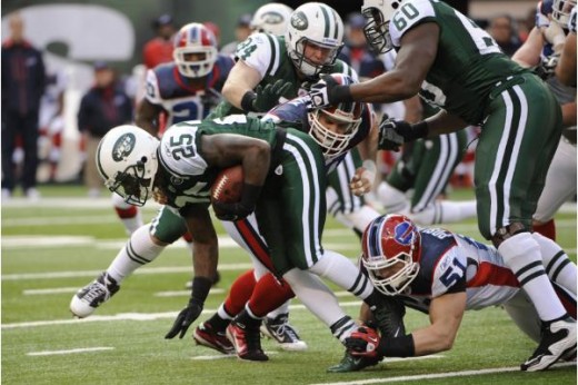 New York Jets' Joe McKnight, left, carries the ball during the first quarter of the NFL football game between the Buffalo Bills and the New York Jets at New Meadowlands Stadium, Sunday, Jan. 2, 2011, in East Rutherford, N.J. (AP Photo/Bill Kostroun)