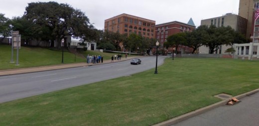 To the left the grassy knoll inclines up and away from Elm Street. Some people nearby thought they heard shots coming from that area. No evidence was ever found to support their claim.