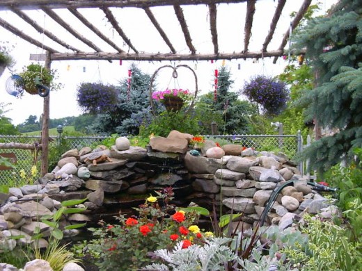 My Pond-we placed each rock and cut cedar trees  for a pergola over pond