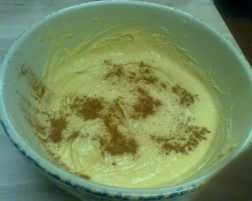 Giant bowl of pumpkin mousse garnished with a sprinkling of ground cinnamon