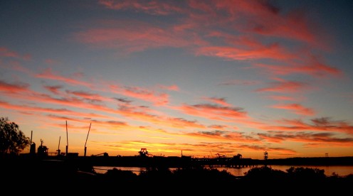 A typical sunset  silhouettes the loading docks on Finucane Island 