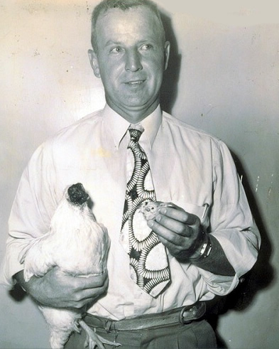 Lloyd Olsen holding Mike the headless chicken and his fake head.