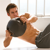 male with dark grey medicine ball with handles 