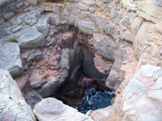 A very deep hole right of the edge of the ocean.