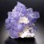 Fluorite is typically purple with rhombohedral crystal shape.