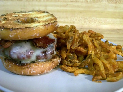 A luther burger: hamburger, bacon, and swiss cheese on a grilled Krispy Kreme doughnut.
