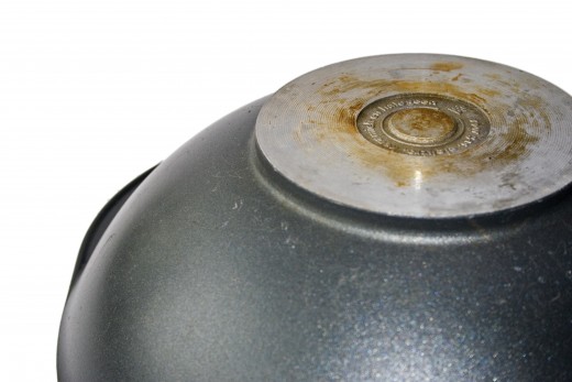 A wok has a narrow or rounded bottom, and wide sides for pushing food around.
