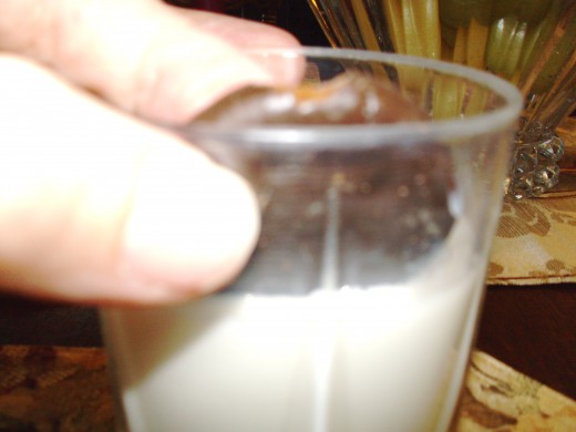 Put the edge of cookie in the milk, with one of the holes below the milk line.