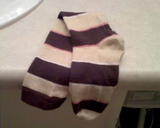 Sock that matches this sock missing since October 2010.  Its twin sock misses it very much.  Please contact if seen.  No questions asked.     Description: brown, tan, and pink striped knee high sock.  Looked adorable with brown flats.