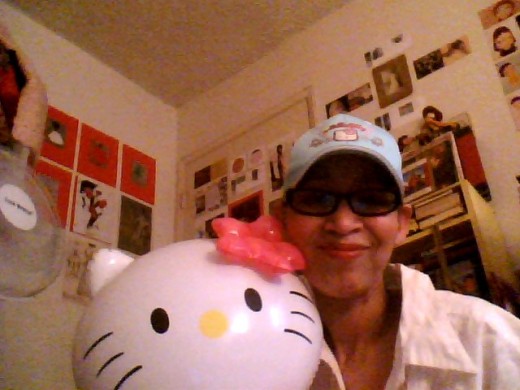 This is me wearing my Hello Ktty baseball cap and holding my Hello Kitty doll.
