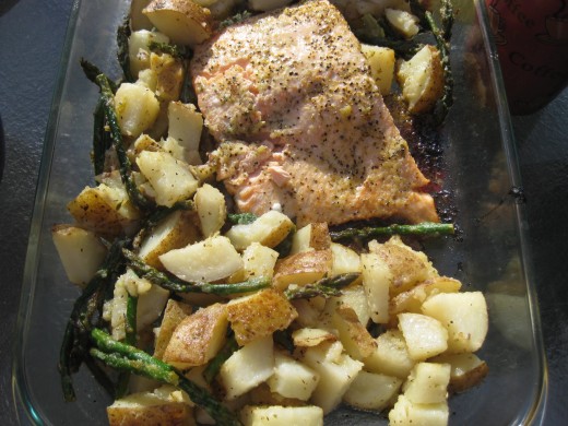 Beautiful baked salmon with lemon, lime, garlic, herbs, and pepper. Served with potatoes that have been baked, steamed asparagus, and steamed mixed vegetables. 
