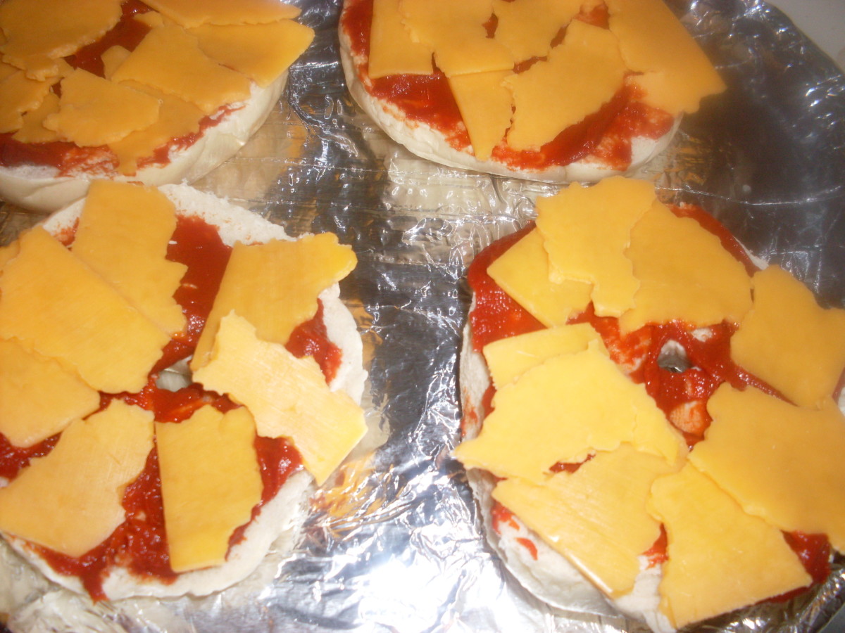 Generous amounts of cheese on the pizza bagels melt in the oven and make the pizza bagels so very delicious.
