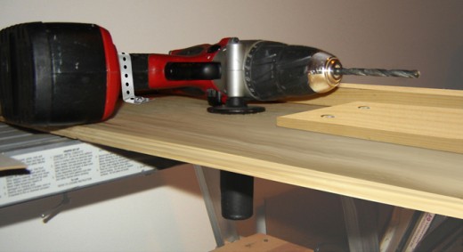 Figure 1: The horizontal grab handle is protruding through a large hole and is seen under the plywood.