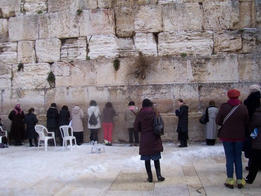 That's me in the long gray raincoat on the right saying a prayer at the Wailing Wall in Jerusalem.