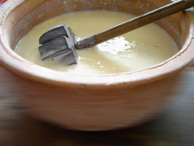 churning the cream with a hand churn
