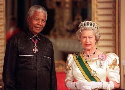 Mandela stands with The Queen on his arrival at Buckingham Palace, for a state banquet in his honour.