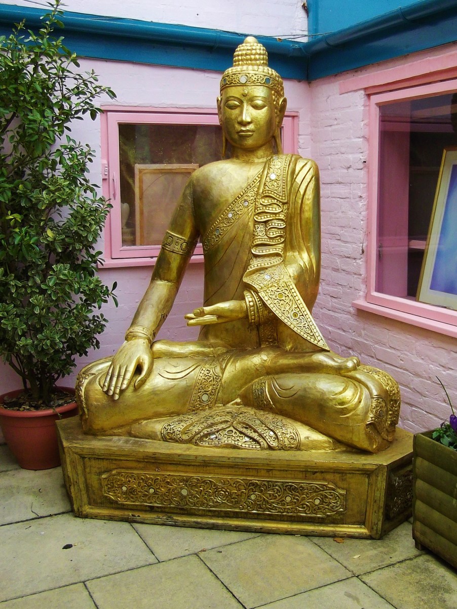 Golden Buddha statue outside a shop in Glastonbury.