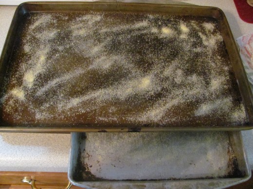 Prepared Pans that have been buttered and sprinkled with cornmeal
