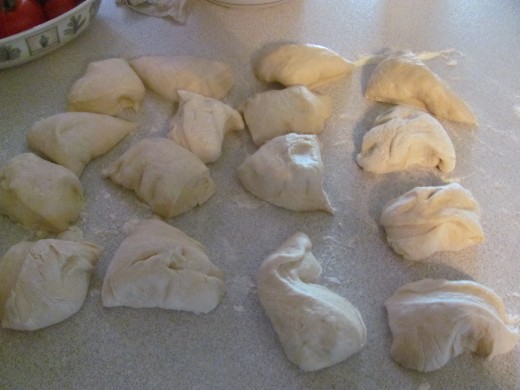 Dough cut into 16 pieces, ready to be formed into balls and rings
