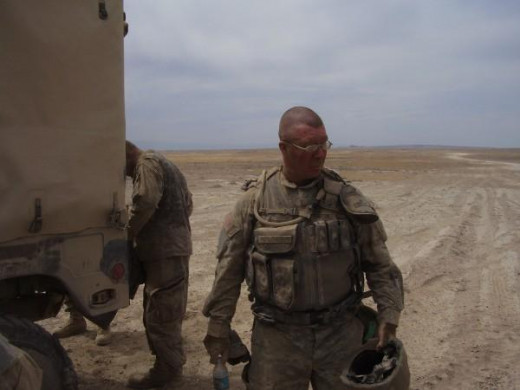 Dust so thick you can't read his name tape. Can't see his skin under the dust.