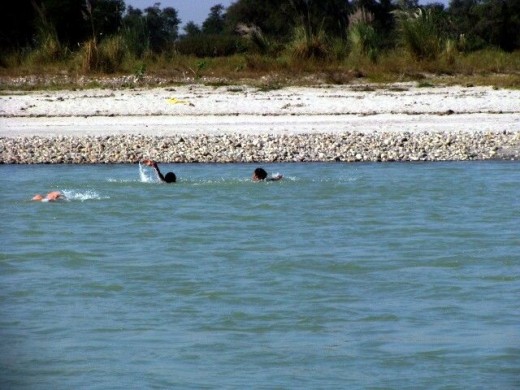 Three men swimming across The River Ganga on our way to Haridwar from Delhi. One of the men in the pic almost drowned but later was able to swim back safely to the surface.
