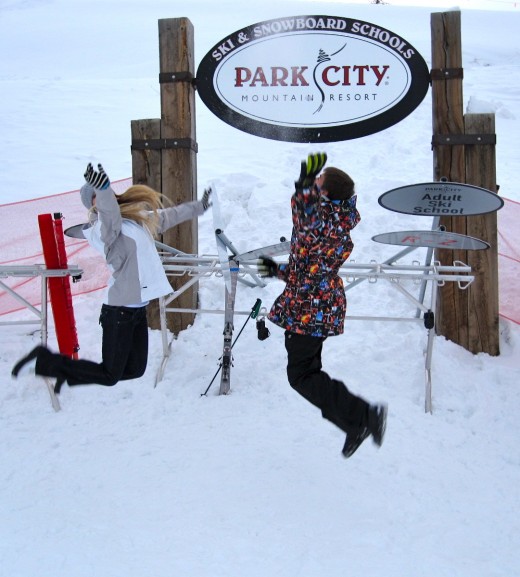 Kids jumping for joy at Park City, Utah ski resort.