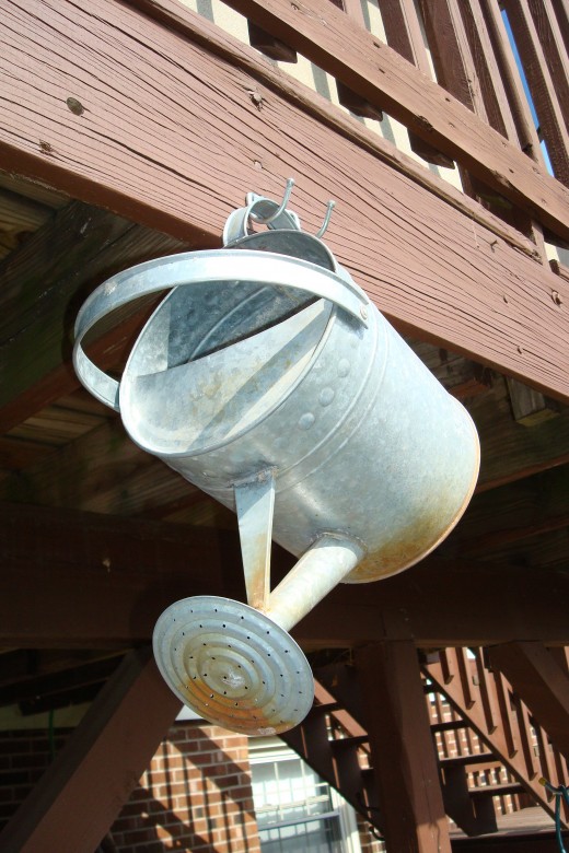 Hang a watering can from a hook for a second story deck