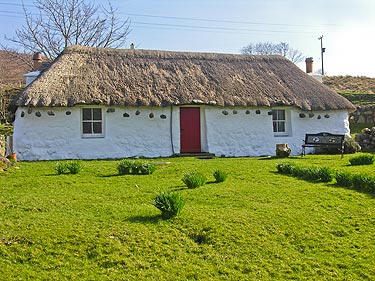 A thatched cottage, probably not unlike the one that the little girl may have lived in.