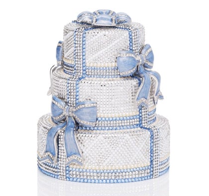 Limited edition, triple tiered wedding cake minaudire with enamel bow accents, top snap closure and 19" chain. Comes lined in an exclusive blue satin. 