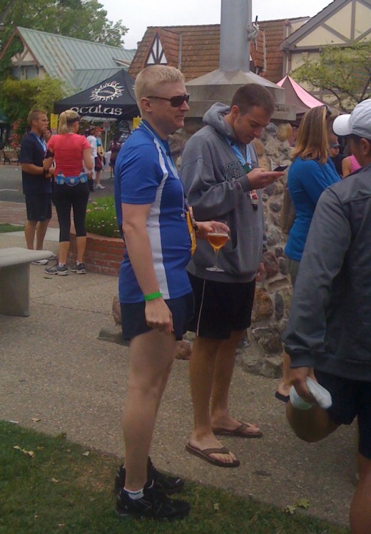 A runner enjoys a cold adult beverage after the race