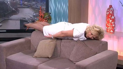 An Australian TV host engagng in a low level  plank.