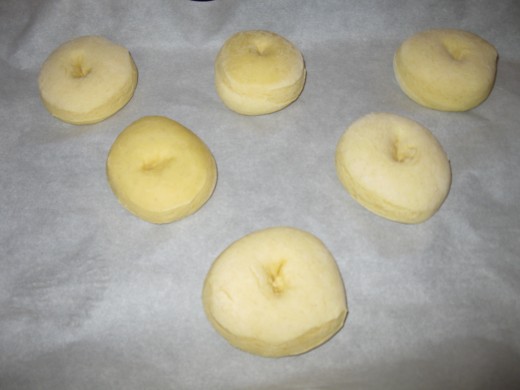 Doughnuts rising on a baking sheet after being frozen!