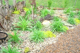 The corner was filled with day lilies during the transformation. This photo was taken in early spring. 