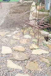 A small stone patio was added to the shade garden, where the gazeo used to be