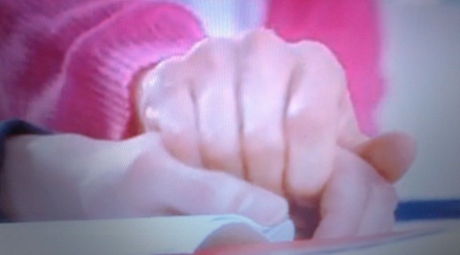YK holds Ys' hand to wake him up, he is sleeping during school time because of working late to pay for YK's tuition fee