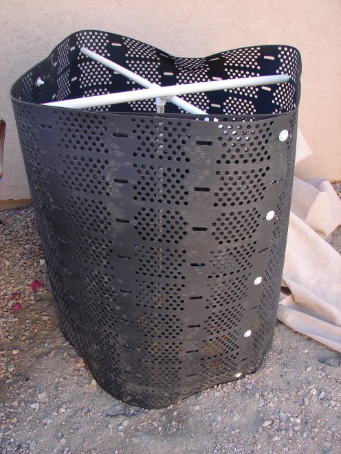 This aerator is a simple affair that keeps the critters out and the heat and air in. My husband put pvc pipe in a criss-cross so it would keep its shape. We cover it with netting and a board on top.