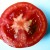 Squeeze tomatoes to remove the pulp and seeds.