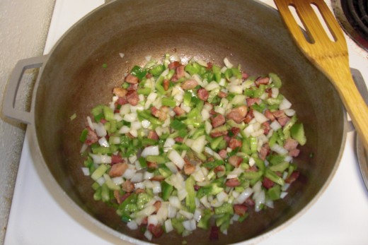 Next add the Holy Trinity (chopped onion, celery and green bell pepper) to the bacon.  The aroma of this combination of country style bacon and fresh chopped vegetables cannot be explained, only enjoyed!  I guarantee!