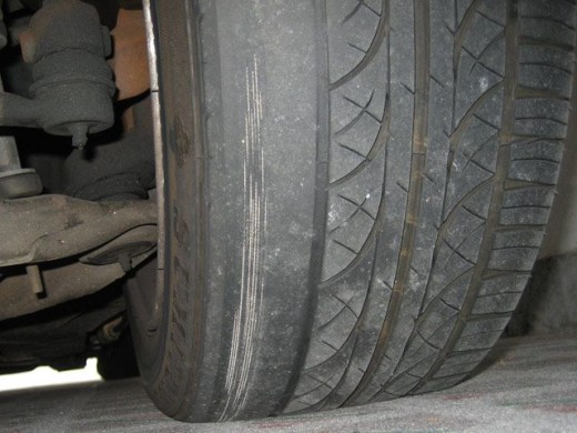 This tire shows extreme inner wear, indicating incorrect camber settings.