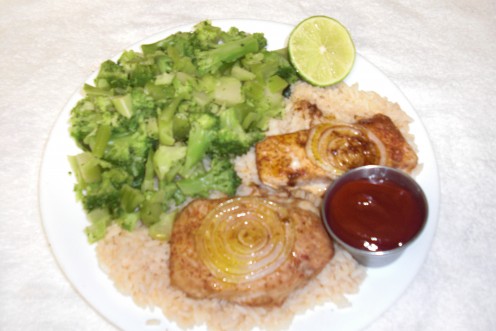 This is the plate of cajun seasoned baked salmon, cajun buttered rice and steamed broccoli pieces.  I also cut a fresh lime and made some cocktail sauce for the salmon.